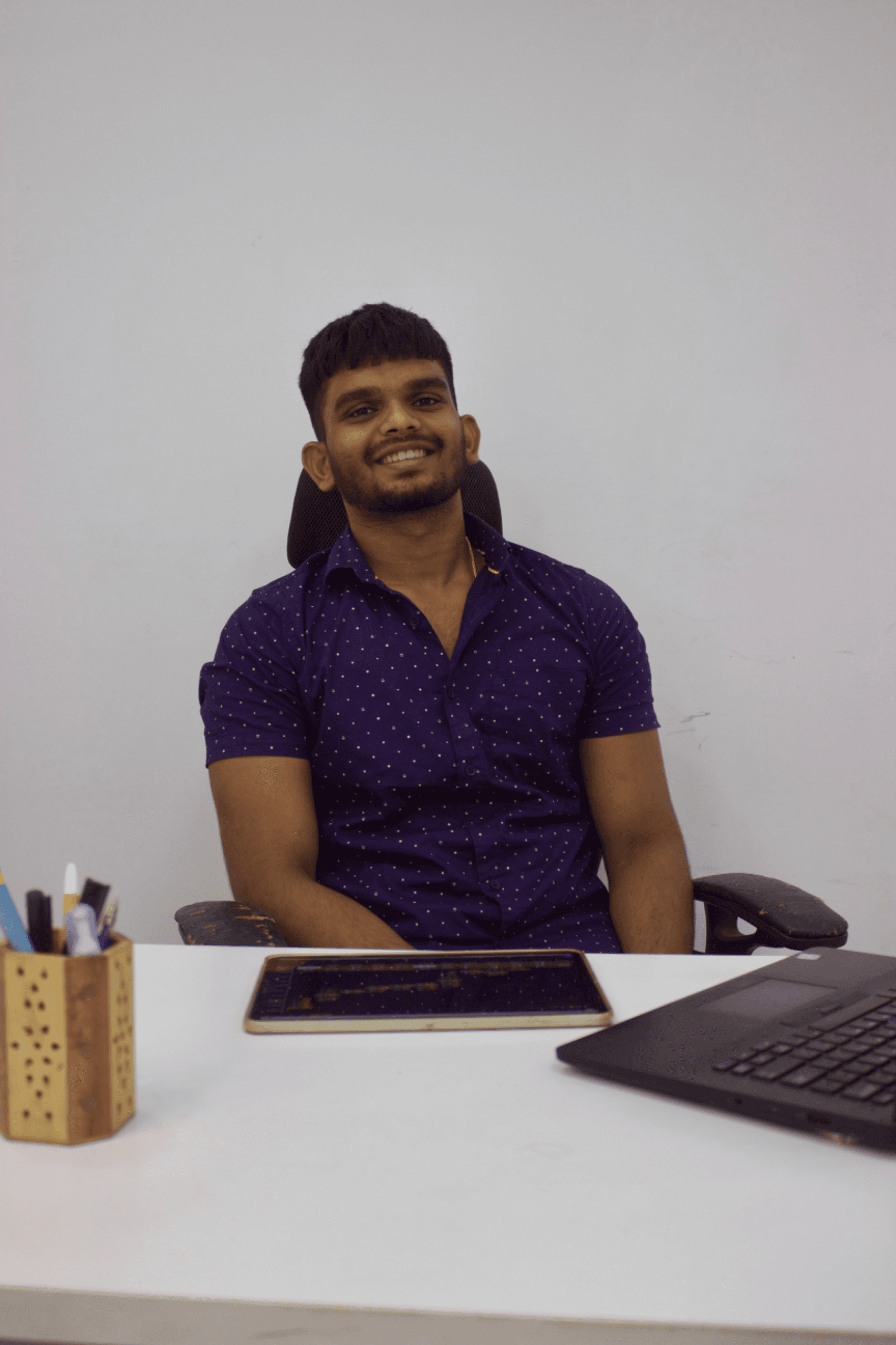Sanjai Mohanbabu smiling at his trading desk